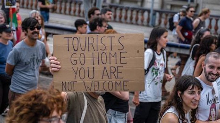 In what ways do tourists damage the environment?